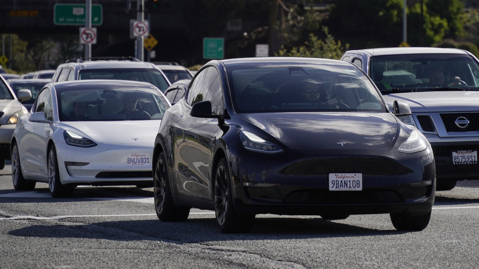 Tesla vehicles drive on the street on February 2, 2024 in San Bruno, California. 