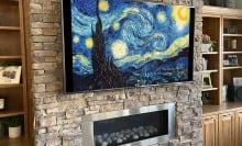 tv displaying Vincent van Gogh's 'starry night' above fireplace