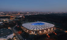 Aerial night view over the illuminated Volksparkstadion