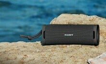 Sony ULT Field 1 speaker sits on a rock near the water