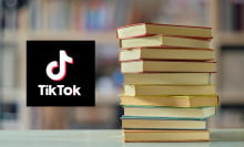 Stack of books next to the TikTok logo. 