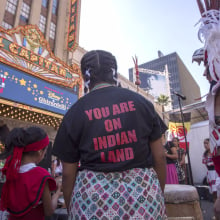 Dancers in a prayer circle during an event celebrating Indigenous Peoples' Day.