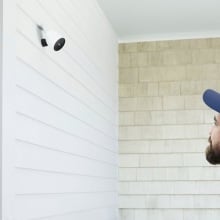 person looking at simplisafe outdoor camera