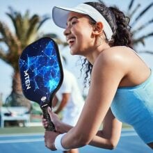 A woman plays pickleball with a MTEN pickleball paddle