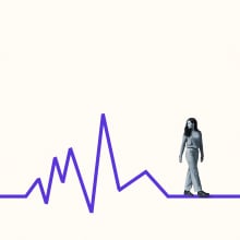 A person walks along a line that mimics a heart rate.