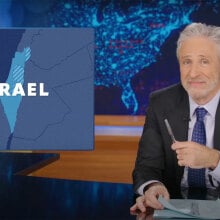 A man sits at a talk show desk while Israel is shown on a map in the top-left corner.