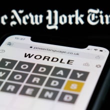 New York Times logo above Wordle on smartphone