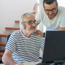 old and young man looking at a computer