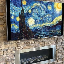 tv displaying Vincent van Gogh's 'starry night' above fireplace