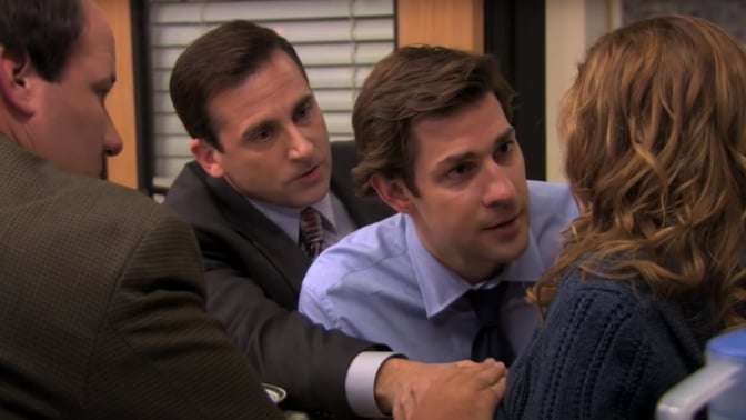 Three men comforting a woman as she goes into labor.