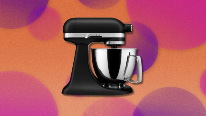 a black kitchenaid mini mixer with a yellow, pink, and purple background