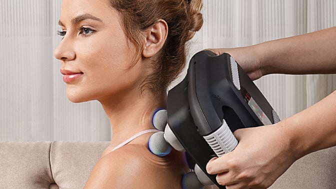 Electric massager being used on back.