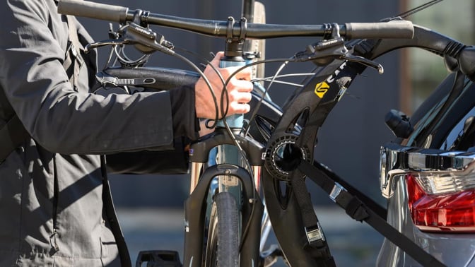 Man hooking up his bike on a bike rack