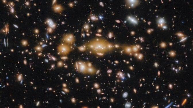 A spectacular view of galaxies captured by the James Webb Space Telescope in deep space, billions of light-years away.