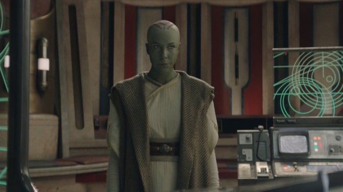 Vernestra Rwoh, a bald, green humanoid alien, in the Jedi Temple.