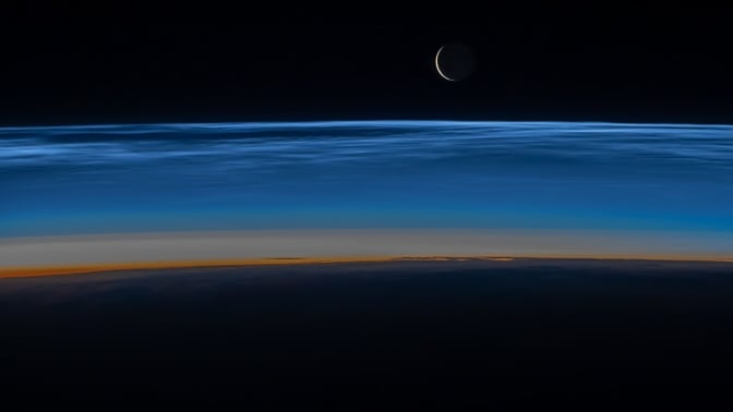 Noctilucent clouds hovering over Earth
