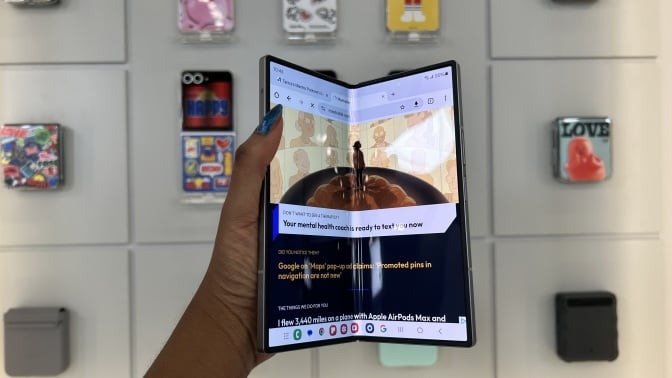 Hand holding Samsung Galaxy Z Fold 6 showcasing main display slightly closed