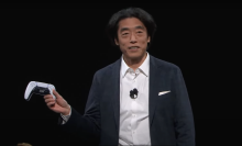 Izumi Kawanishi holding a DualSense controller