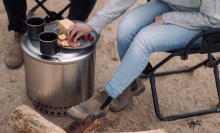 campers sit around the Solo Stove and have snacks