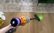 Person's hand holding Dyson V12 Detect Slim cordless vacuum