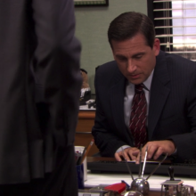 A man (Steve Carell as Michael Scott on "The Office") tuning up the volume on his computer.