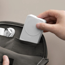 person sliding Anker 3-in-1 foldable charging station into bag