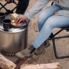 campers sit around the Solo Stove and have snacks