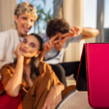 group of friends taking selfie with pink Motorola razr+ phone