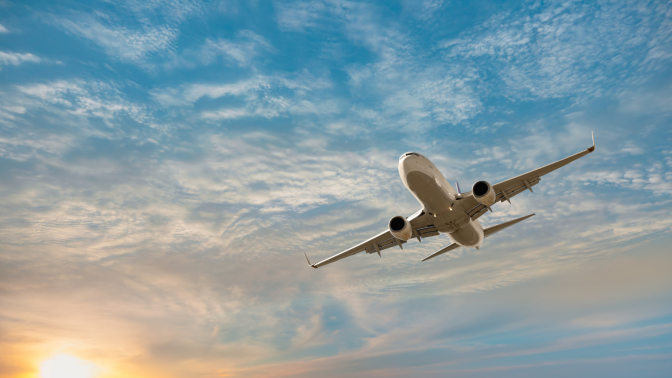 plane flying in cloudy sky