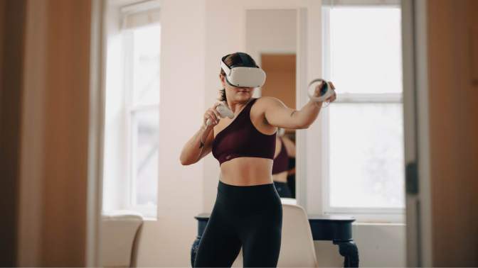 woman in workout clothes wearing VR headset 