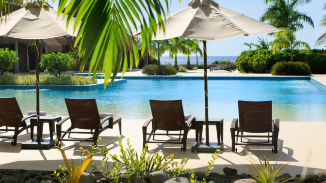 Lounge chairs by the pool at a resort