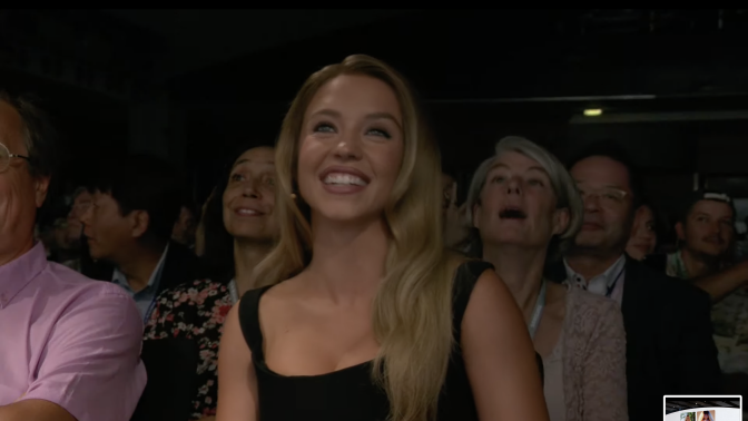 Sydney Sweeney beaming in the audience of Samsung Unpacked 2024.